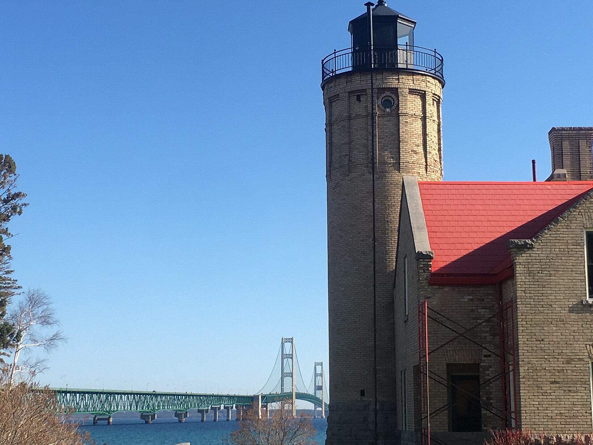 Old Mackinac Point Lighthouse with the Mackinac Bridge in the background, Mackinaw City, Michigan.
